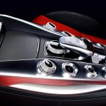 The stylish center console with aluminium elements between black and red sports auto chairs